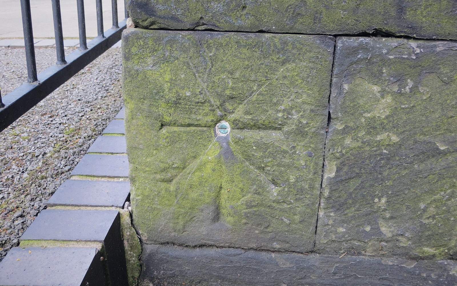 A cut survey benchmark in stone, close