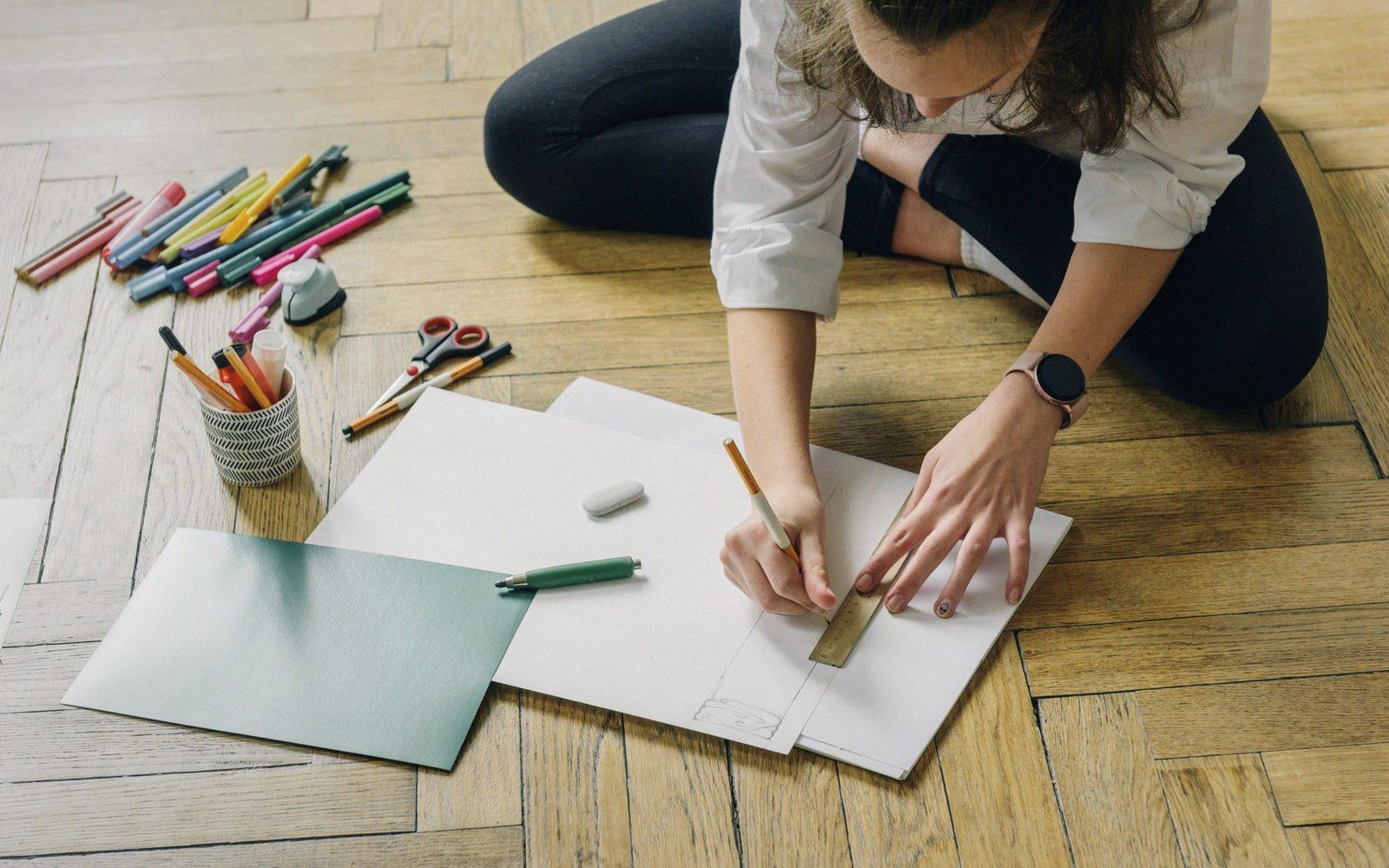 Hands laying a transparent overlay over a printed grid